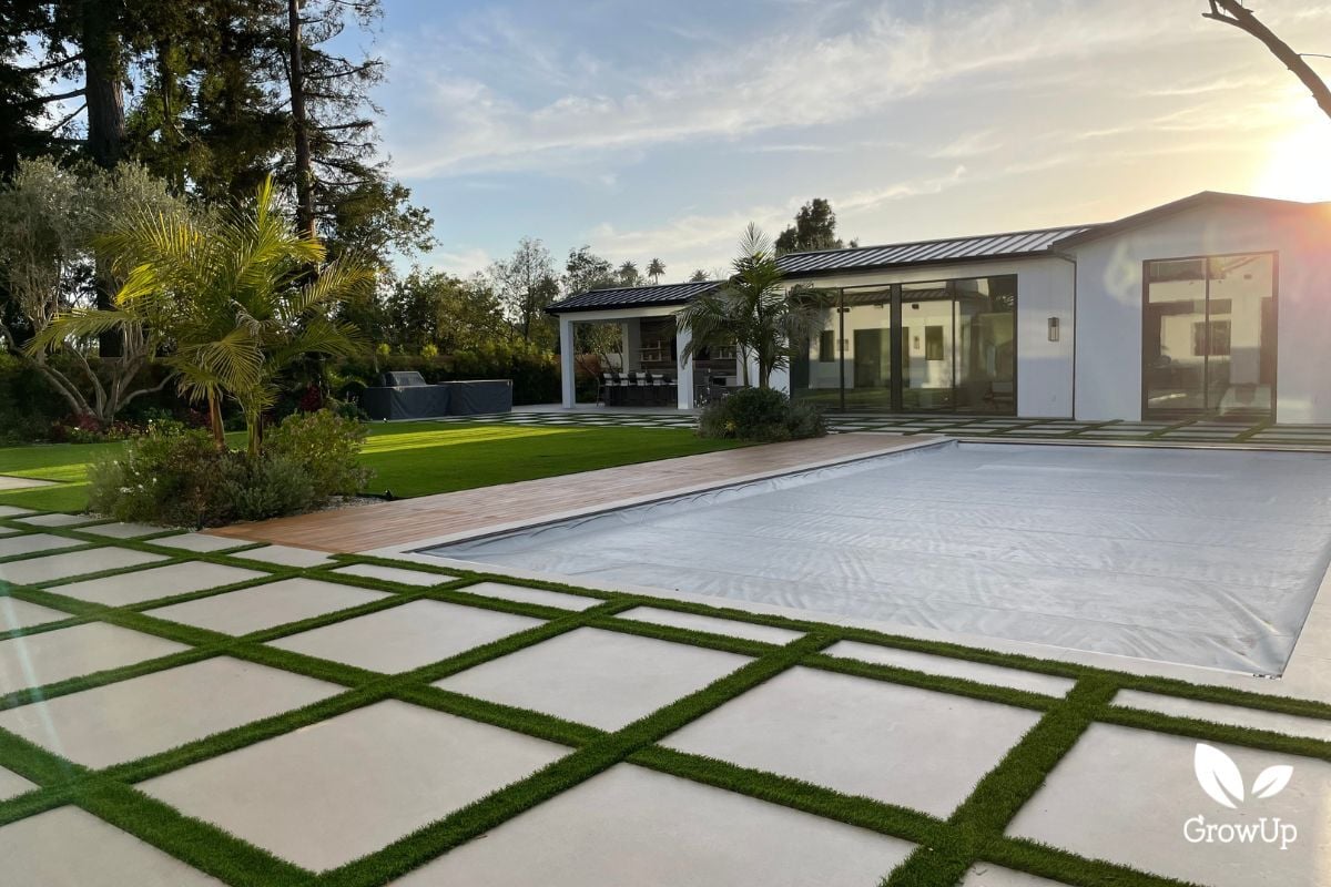 View over pool to pool house that has a large living greenwall