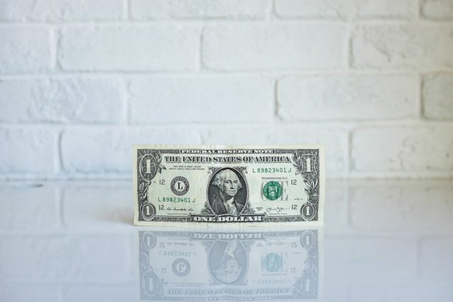 A dollar bill on a table